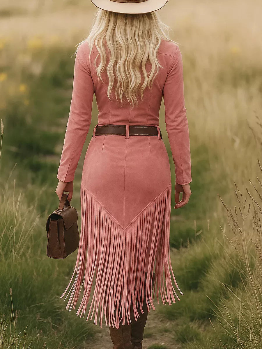 Woman in a pink fringe dress walking through a field