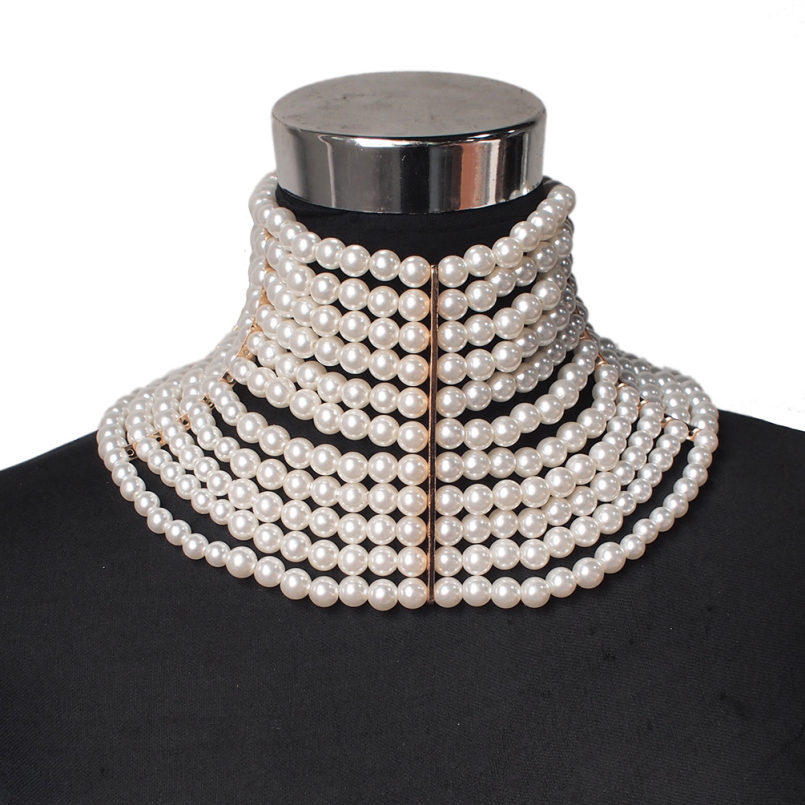 Multiple layers of pearl necklace on a mannequin with a white background