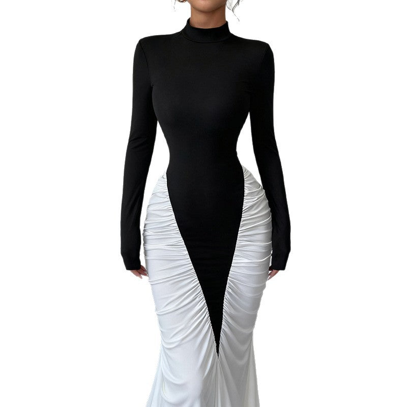 Black long-sleeve top and white ruched skirt set on a white background