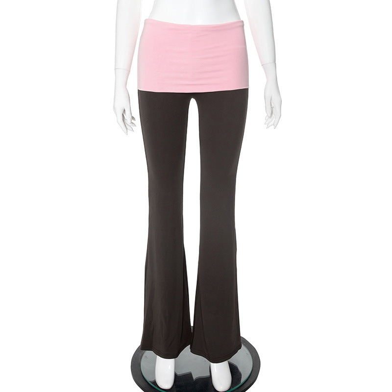 Mannequin wearing black pants and a pink top on a white background