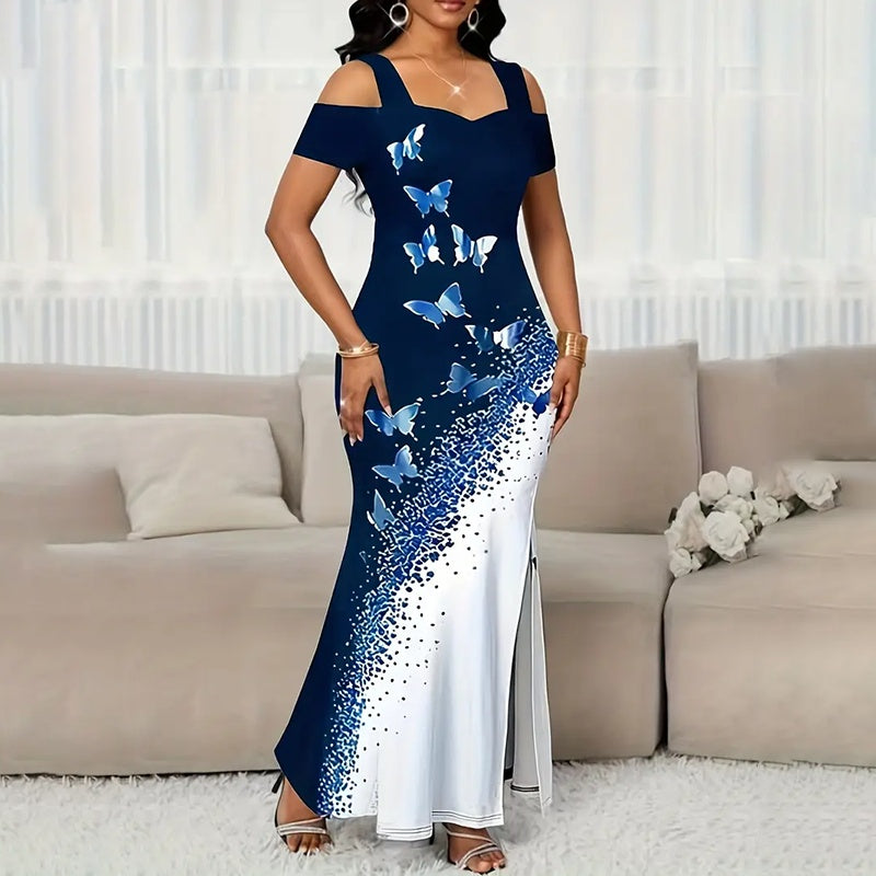 Woman wearing a blue and white dress with butterfly patterns in a living room.