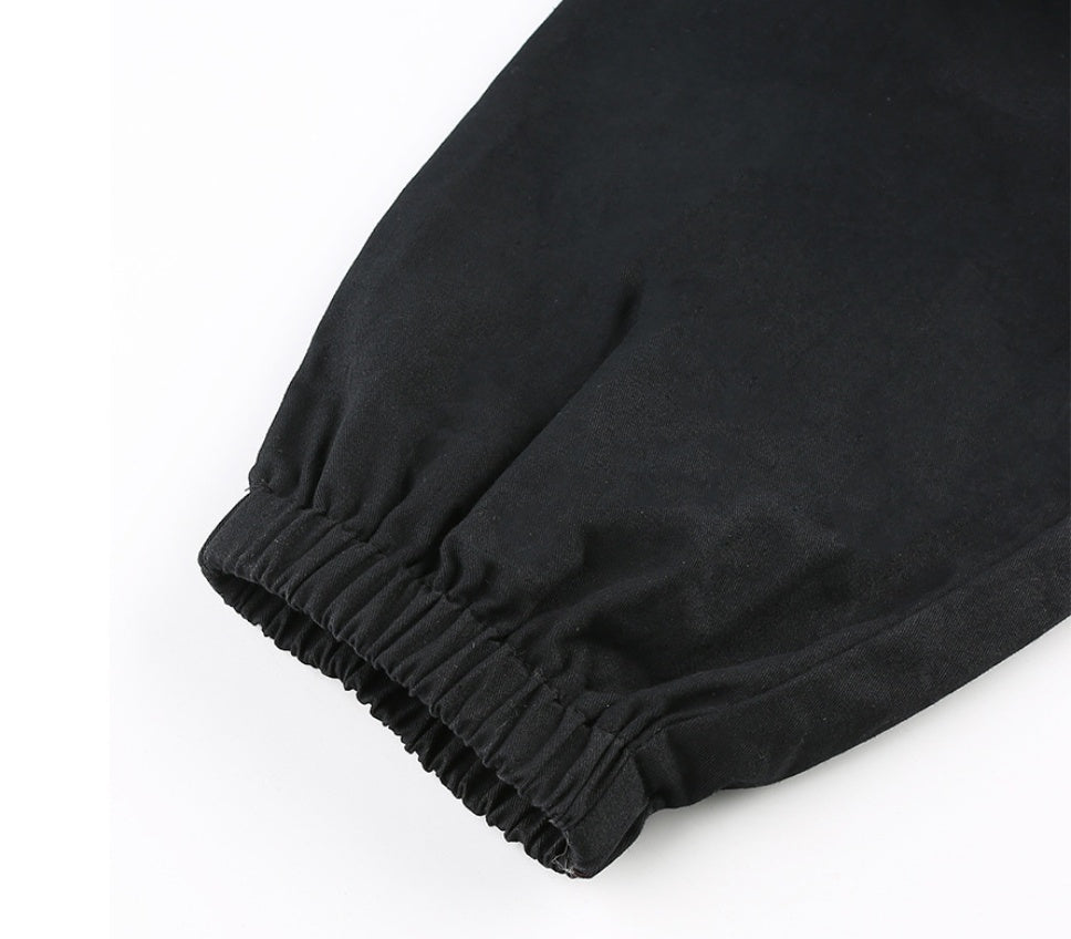 Close-up of black pants with a white background