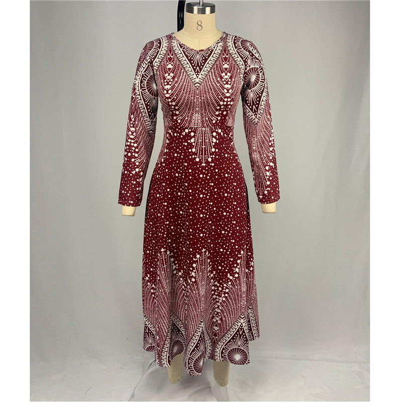 Red dress with intricate patterns on a mannequin against a gray background