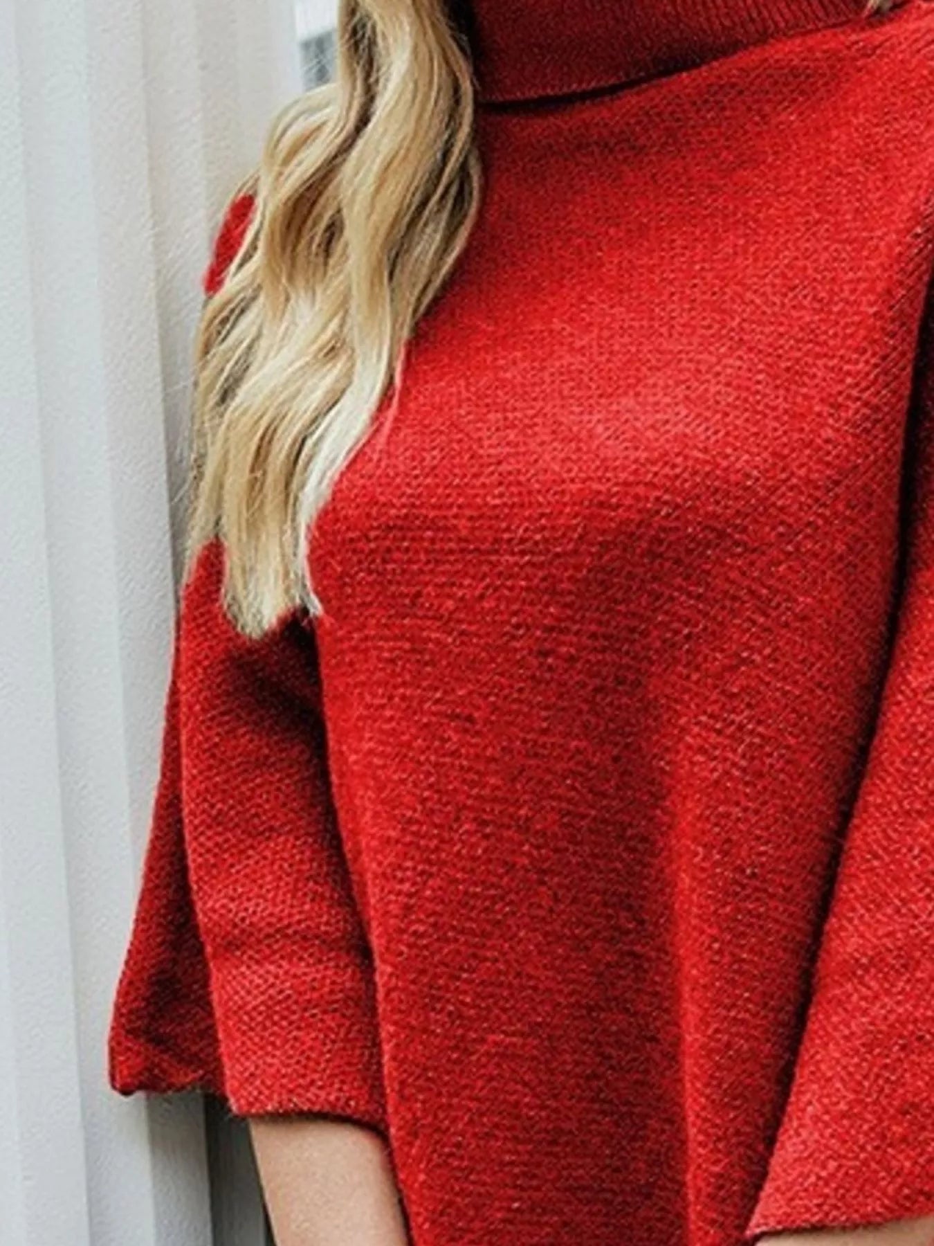 Close-up of a red sweater with a blurred background