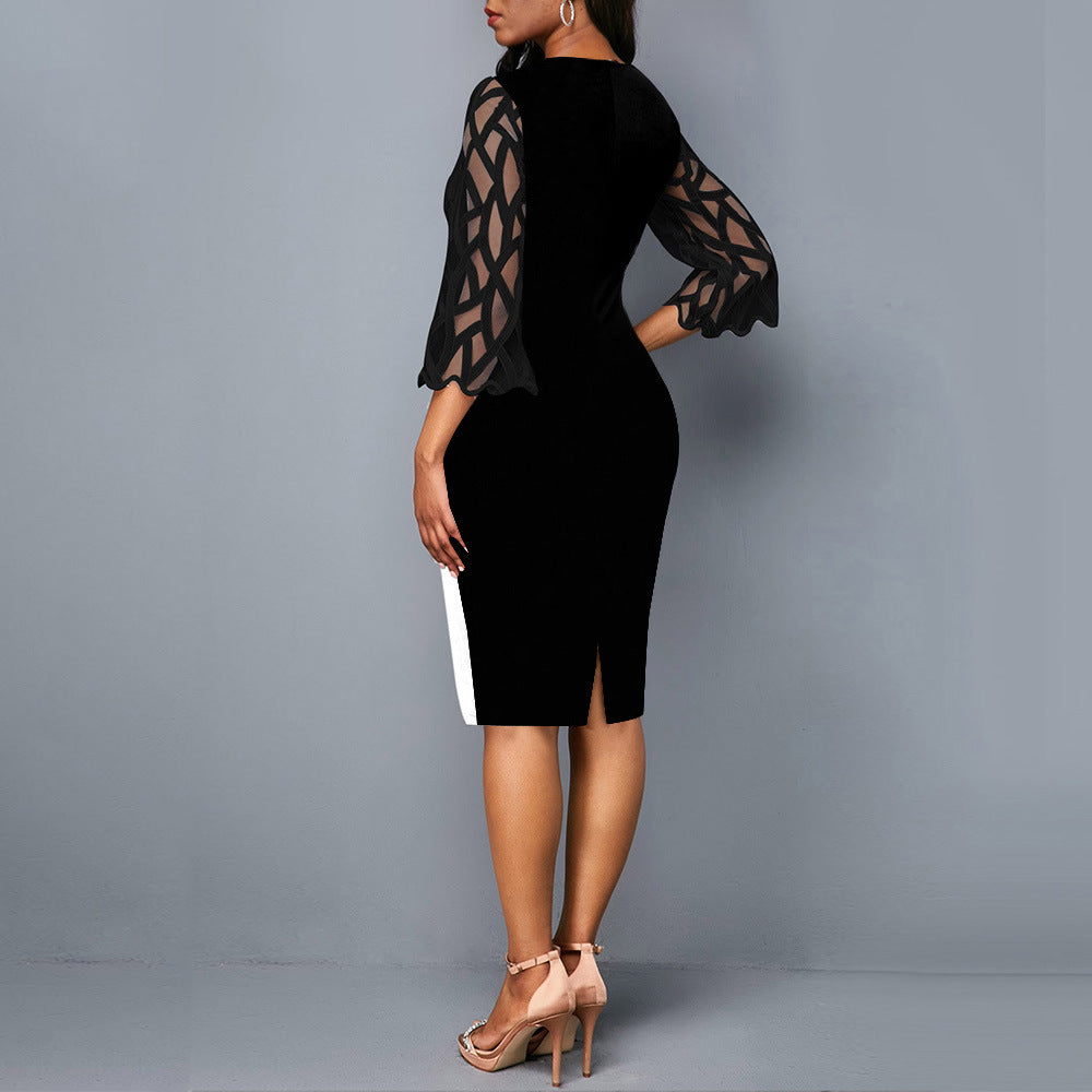 Black dress with sheer sleeves on a gray background