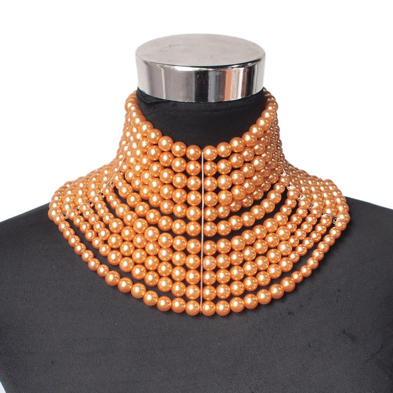 Mannequin wearing a multiple-layered pearl necklace on a white background