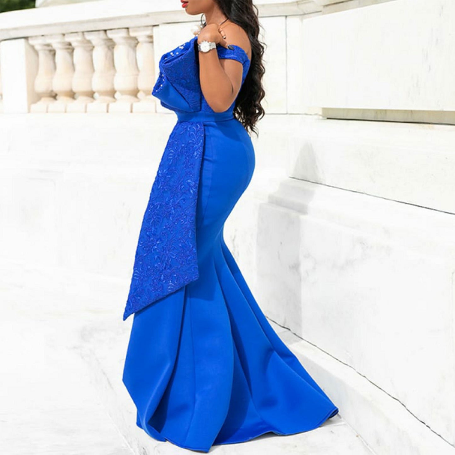 Woman wearing a blue evening gown with a white background