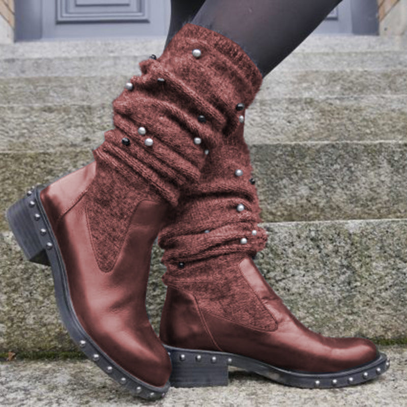 Brown knee-high boots with studded details on a stone step.