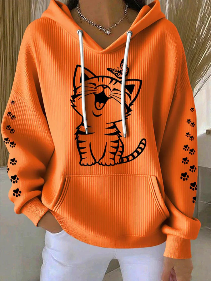 Orange hoodie with a tiger design and paw prints on a neutral background