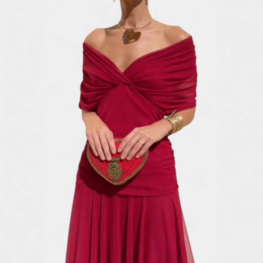 Red off-shoulder dress with a matching heart-shaped clutch on a white background