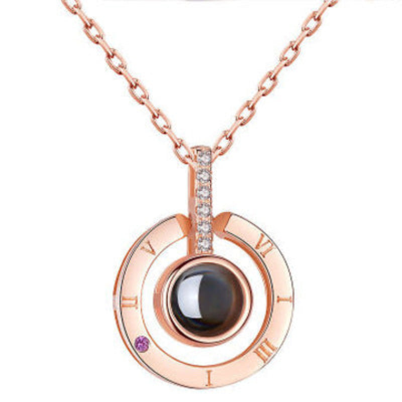Rose gold necklace with a pendant featuring a black gemstone on a white background