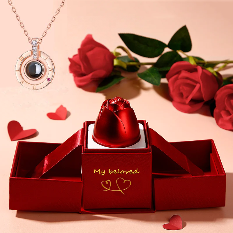 Red rose-shaped jewelry box with 'My beloved' text, necklace, and red roses on a pink background