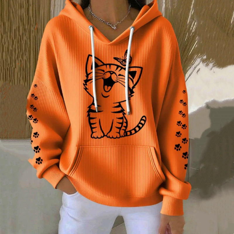Orange hoodie with a tiger design and paw prints on a neutral background