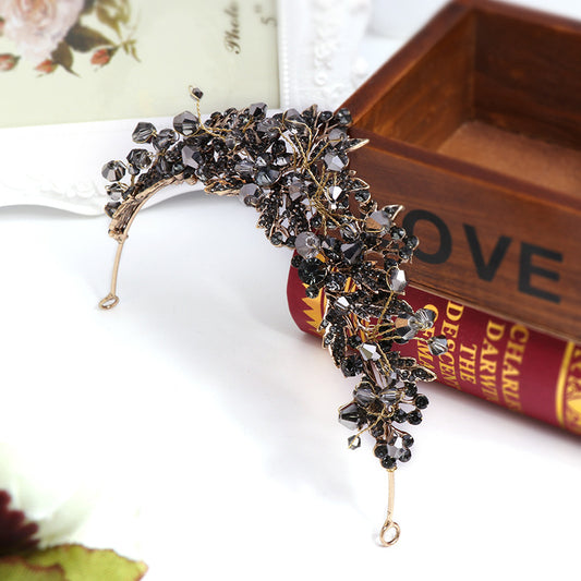 Decorative headband with crystals on a white surface with a book in the background