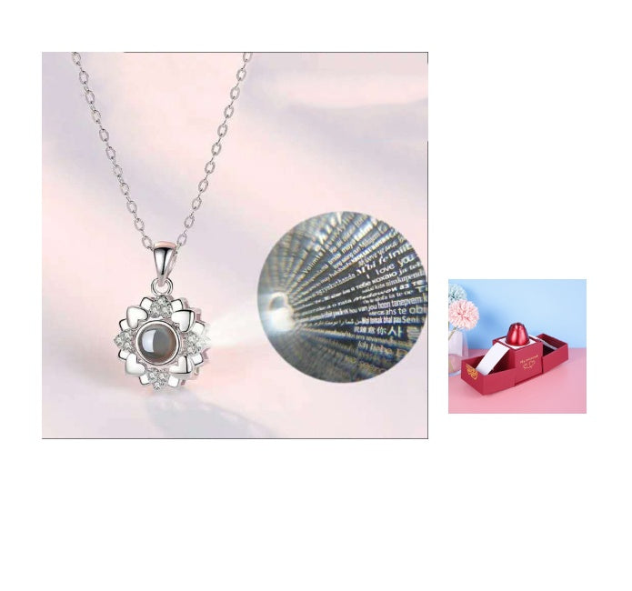 Silver necklace with a pendant on a light pink background
