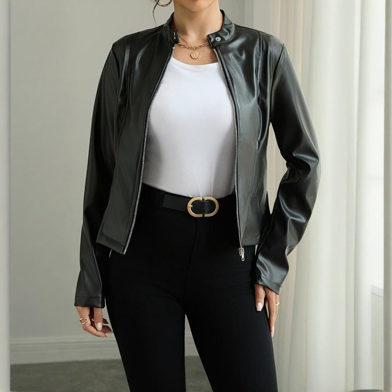 Person wearing a black leather jacket over a white top and black pants.
