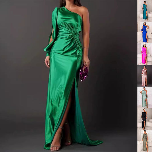 Green one-shoulder evening gown with side slit on a gray background