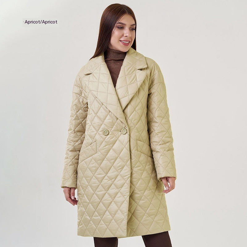 Woman wearing a beige quilted coat on a light gray background