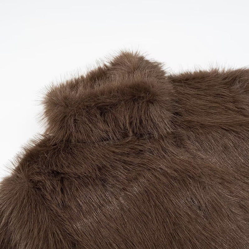 Close-up of brown faux fur fabric on a white background