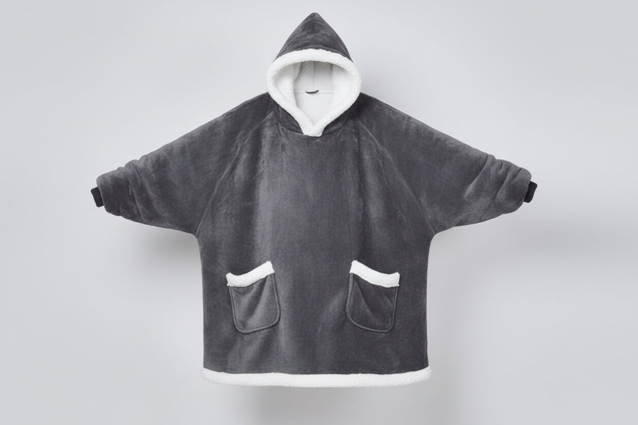 Person wearing a gray fleece poncho with white trim on a white background