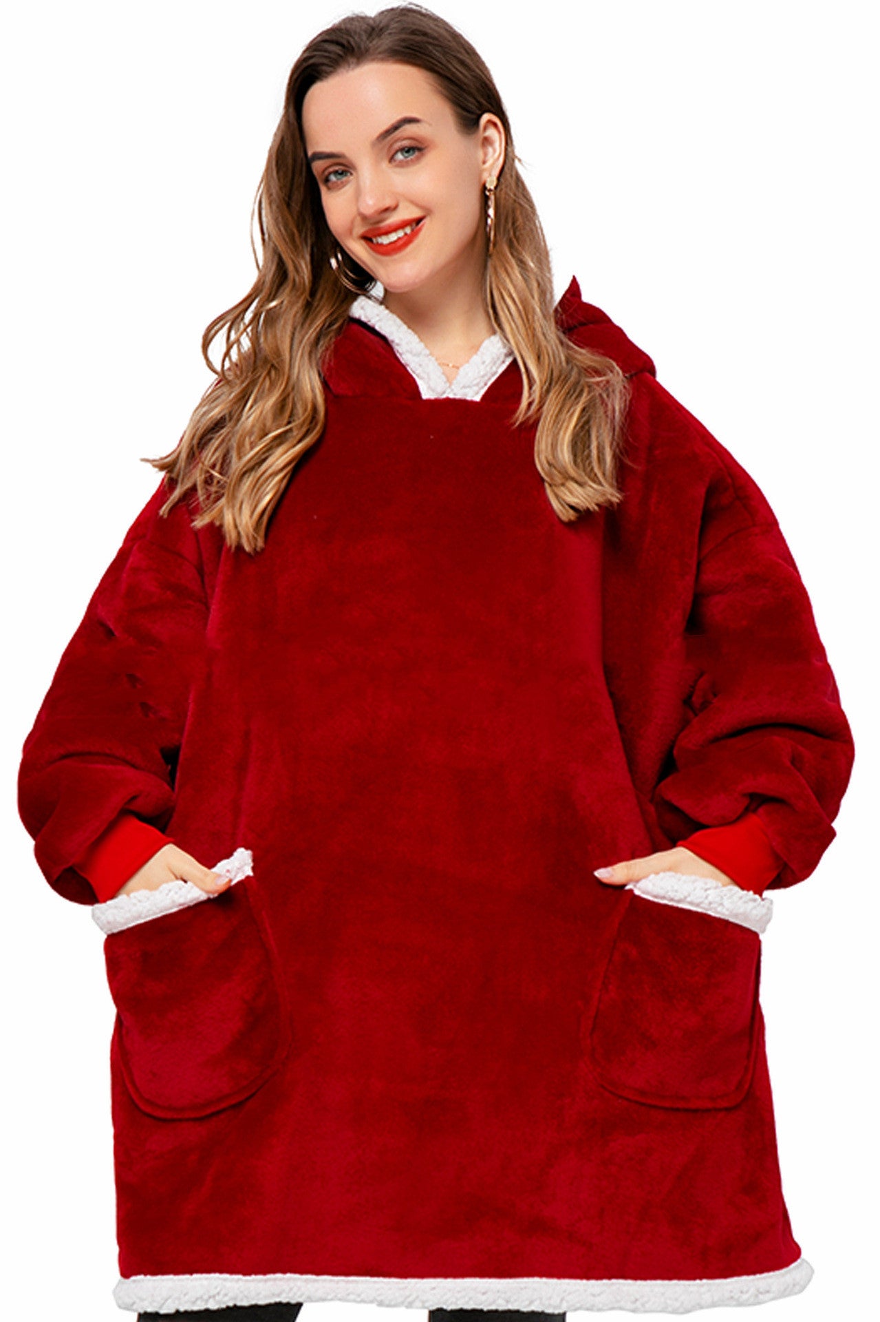 Woman wearing a red fleece poncho with white trim on a white background
