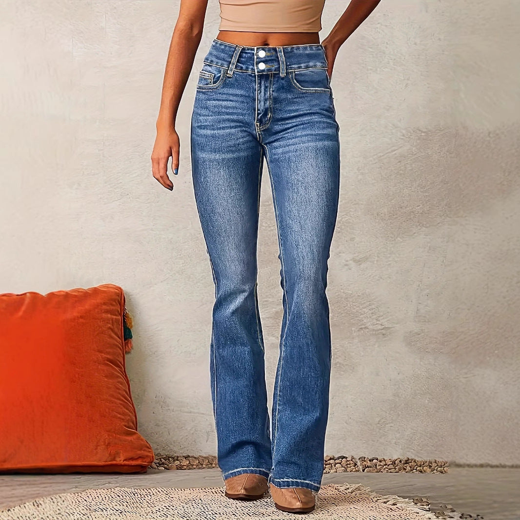 Person wearing blue jeans standing against a neutral wall with an orange pillow on the floor.