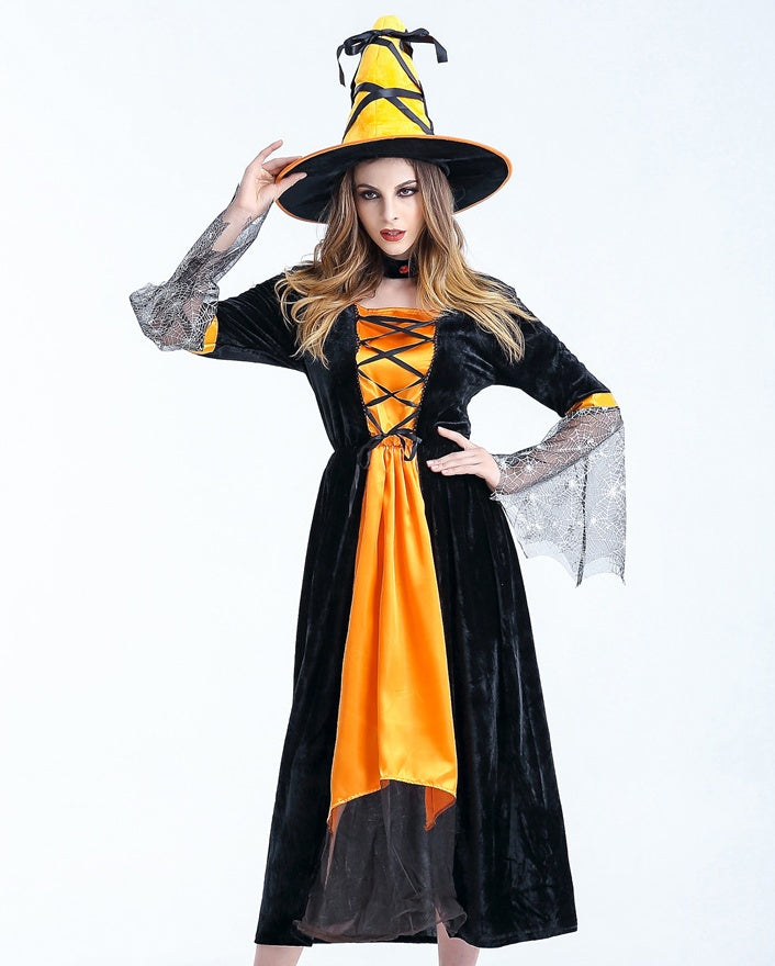 Person wearing a black and orange witch costume with a hat on a white background