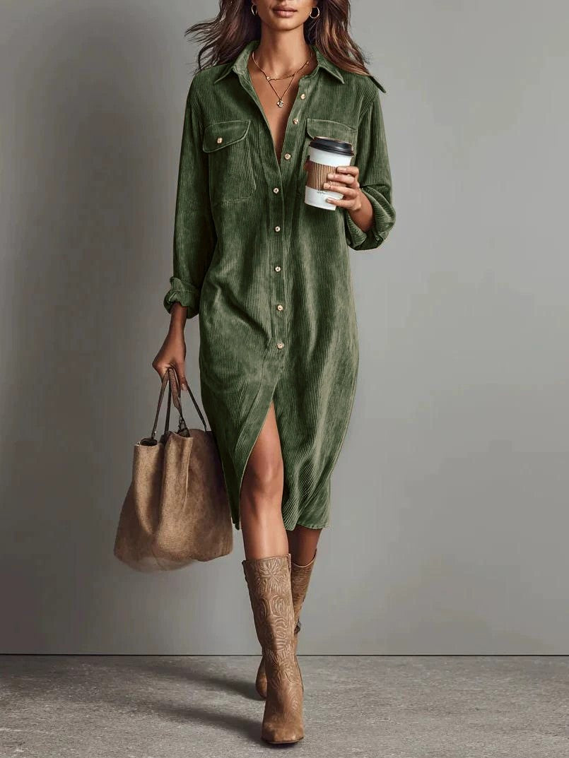 Woman wearing a green dress holding a coffee cup and brown bag against a gray background