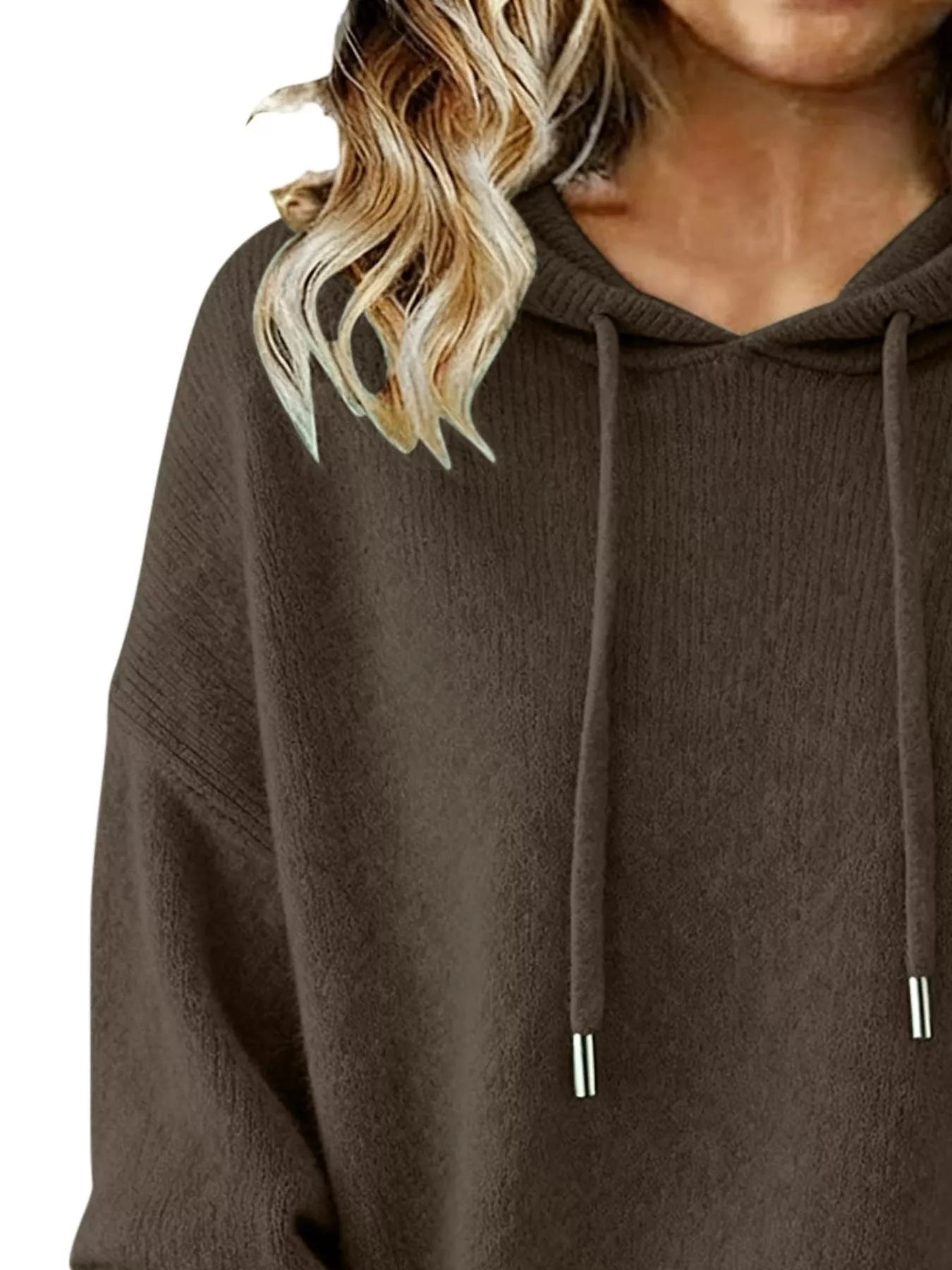 Brown hoodie worn by a person with blonde hair on a white background