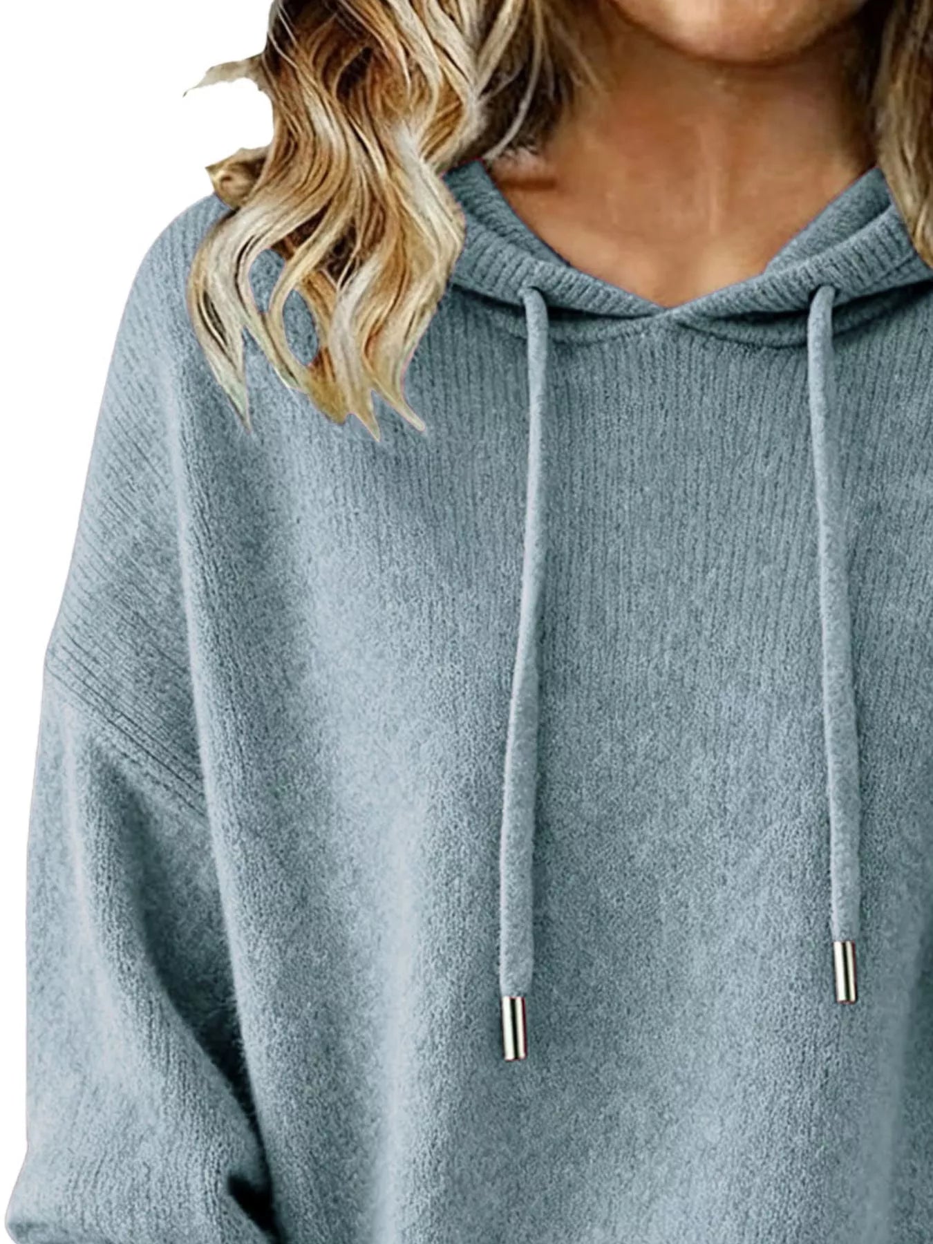 Blue hoodie worn by a person with blonde hair, on a white background