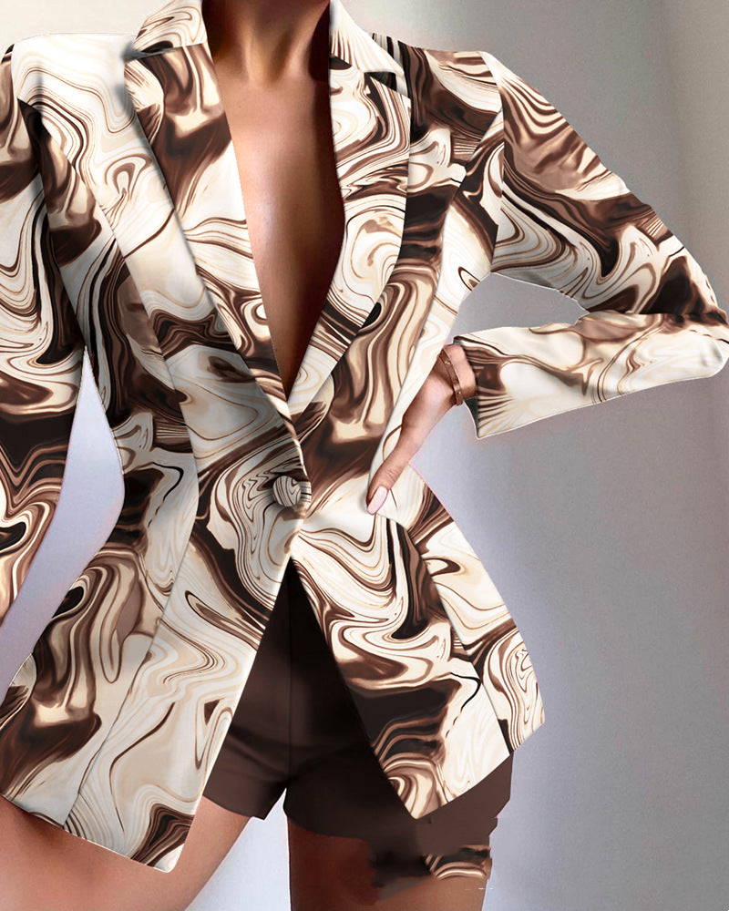Marbled patterned blazer worn by a person on a plain background