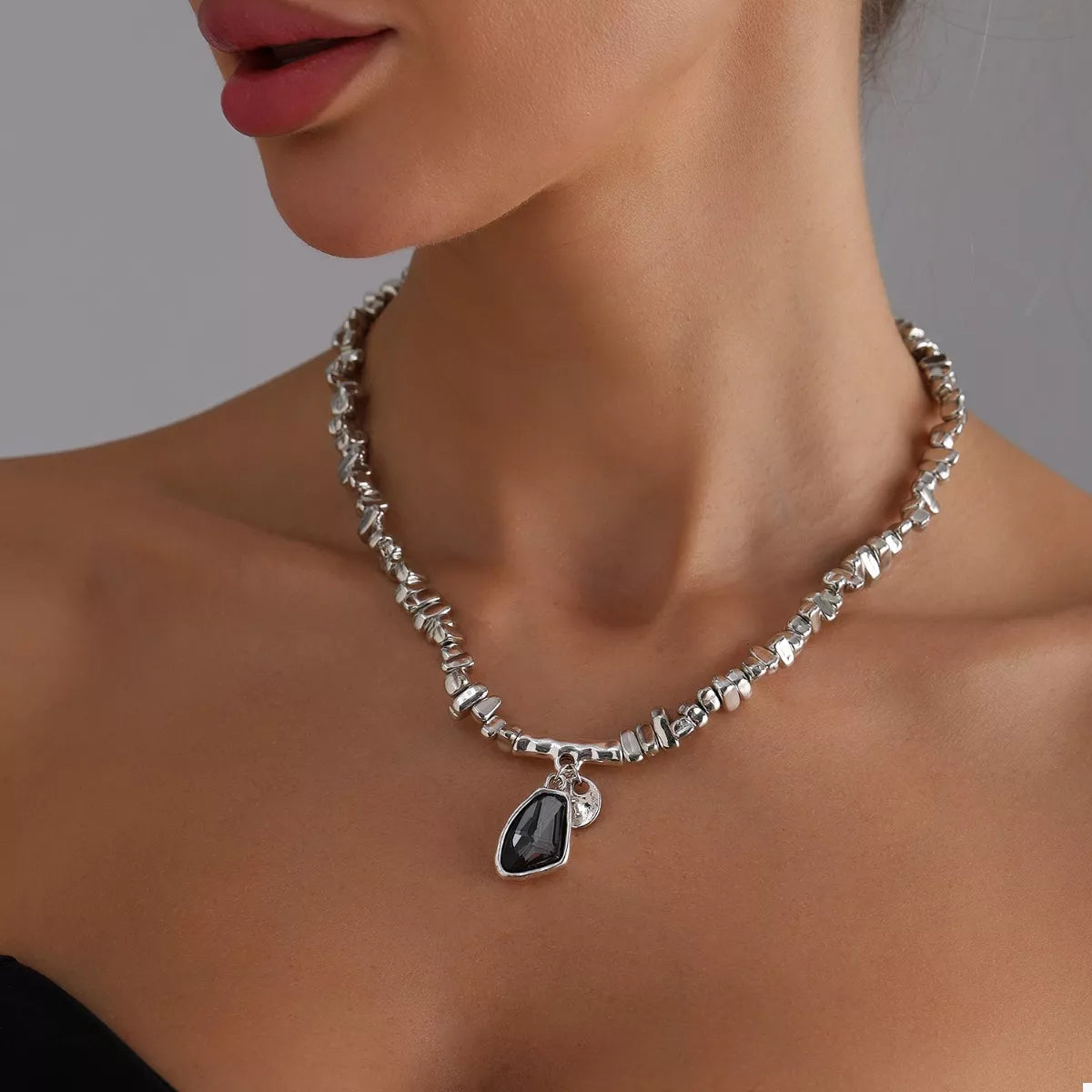 Necklace with a pendant worn by a model on a neutral background