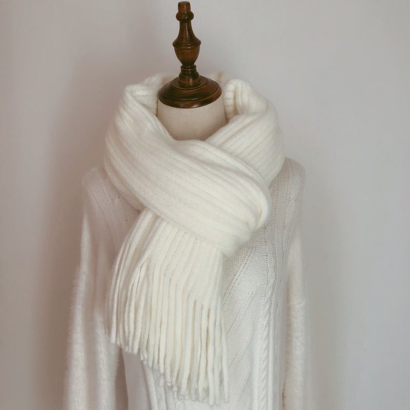 White scarf on a mannequin against a plain background
