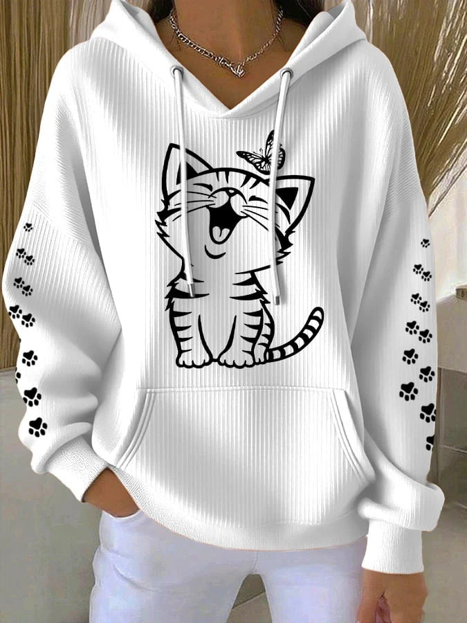 White hoodie with a black tiger design and paw prints on a neutral background