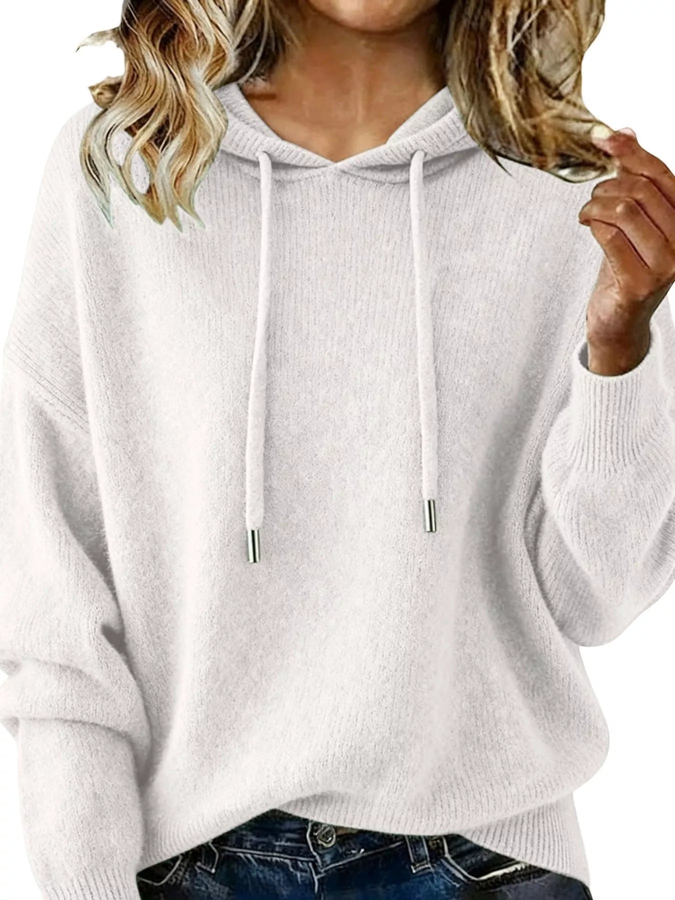 Person wearing a light gray hoodie with a plain background