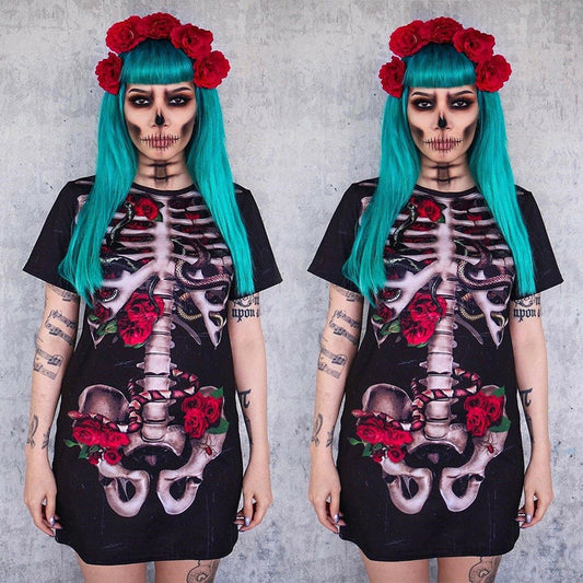 Person wearing a black dress with skeleton and floral design against a gray background
