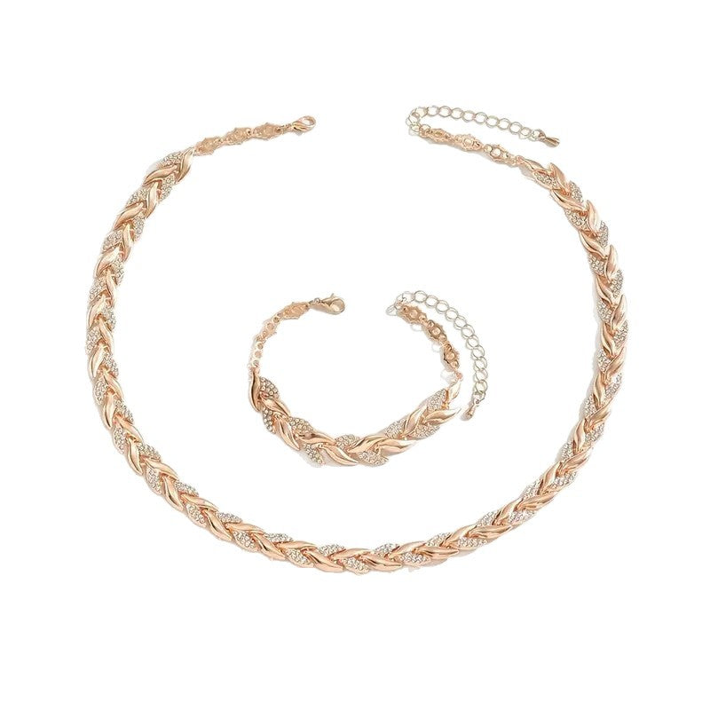 Rose gold braided necklace and bracelet set on a white background
