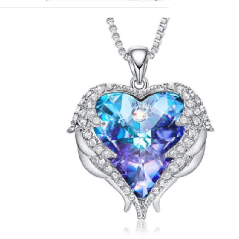 Heart-shaped blue gemstone pendant with silver frame on white background