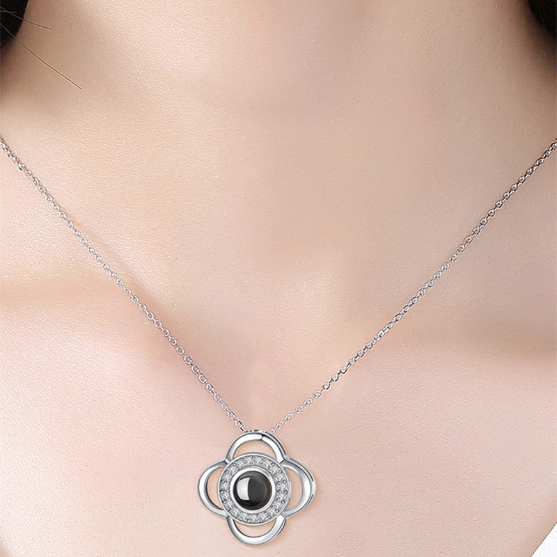 Silver necklace with a black gemstone pendant on a person's neck