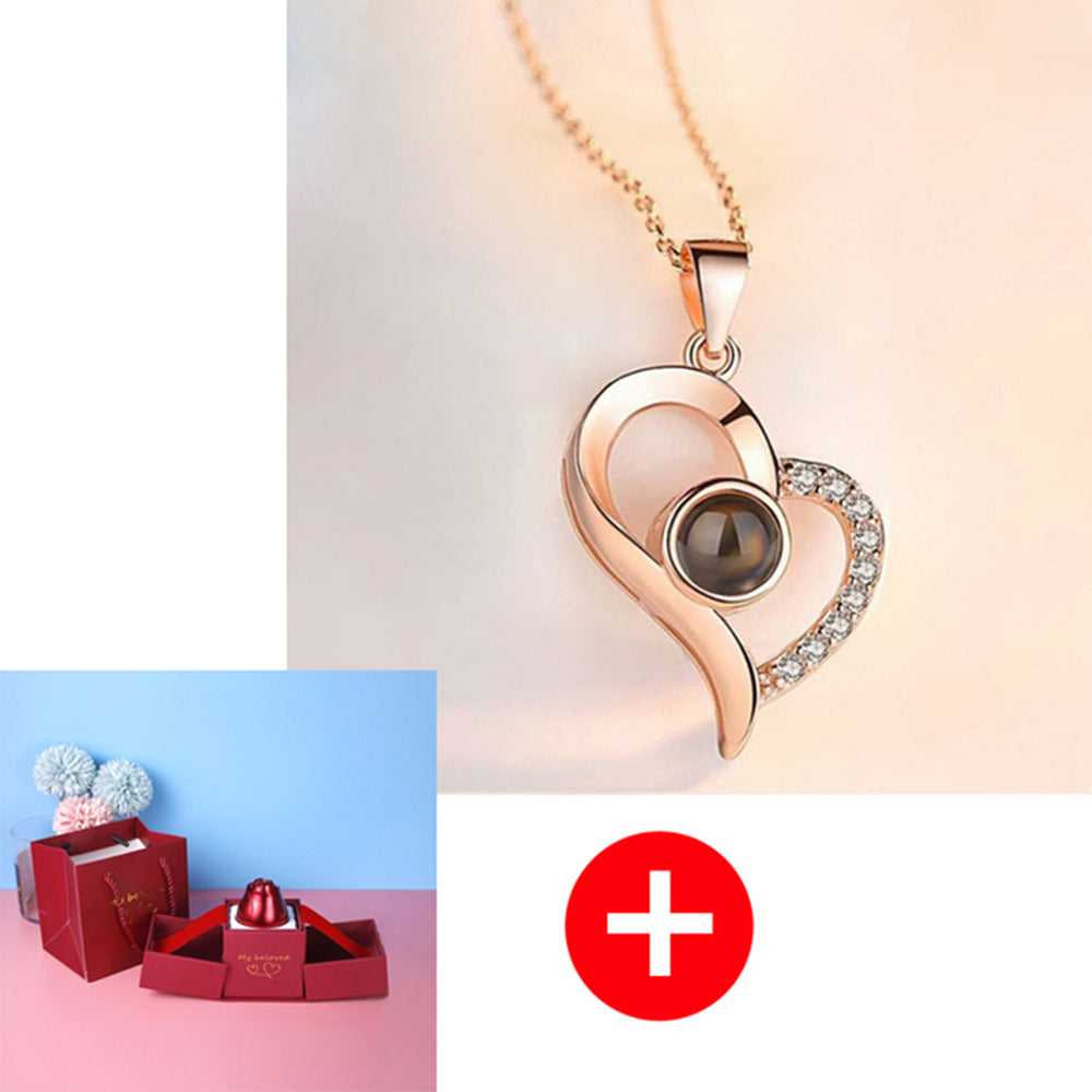 Heart-shaped pendant necklace with a red gift box in the corner