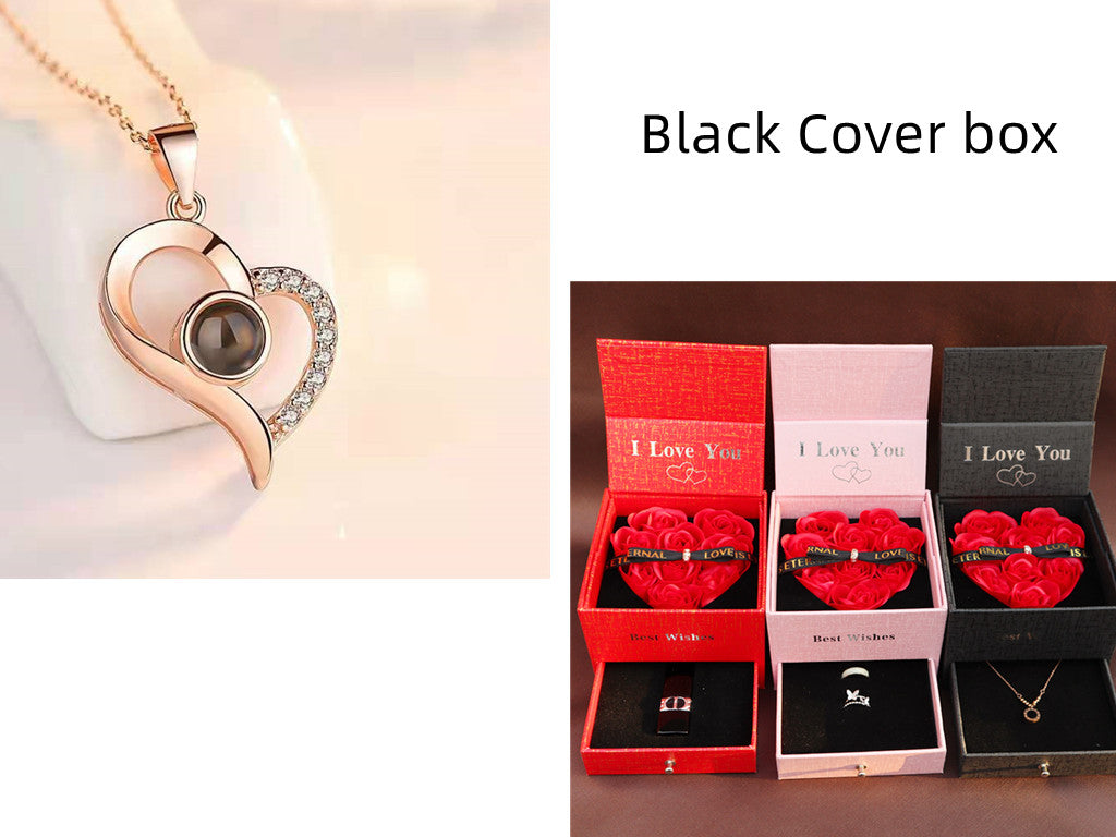 Heart-shaped necklace with a black gemstone and packaging featuring 'I Love You' boxes.