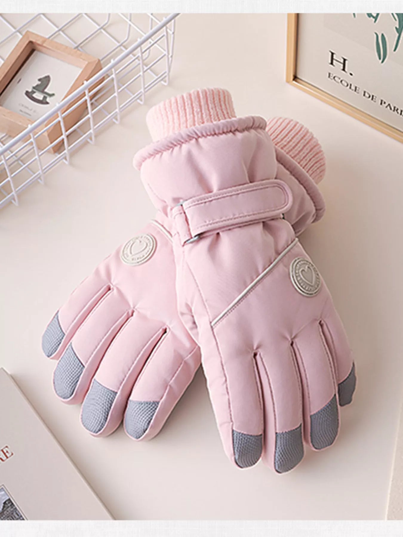 Pink gloves with gray tips on a light surface