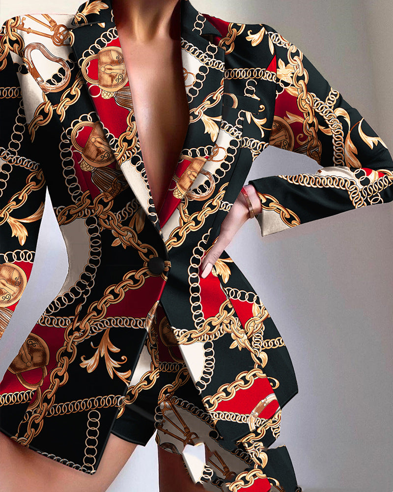 Patterned outfit with gold chains and red accents on a plain background