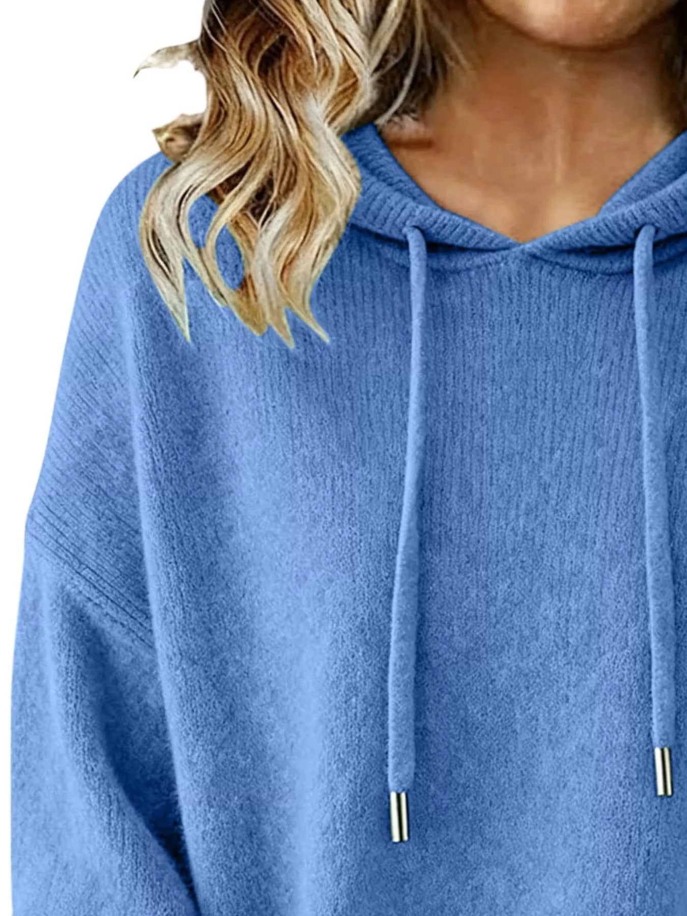 Blue hoodie worn by a person with blonde hair, close-up view.