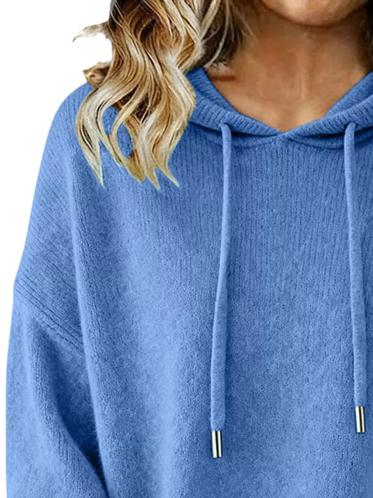 Blue hoodie worn by a person with blonde hair, close-up view.