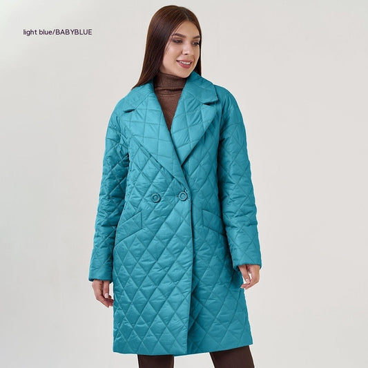 Woman wearing a light blue quilted coat on a white background