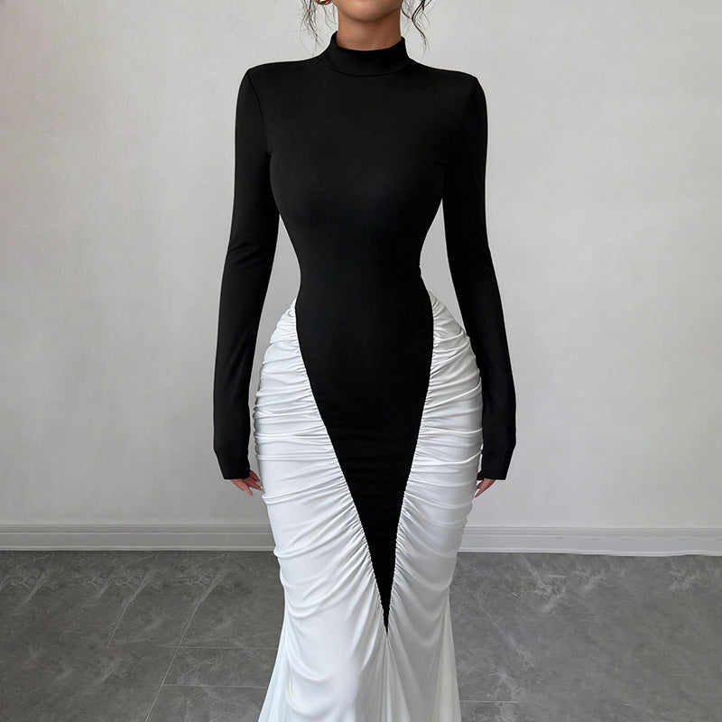 Black and white dress with a high slit on a plain background