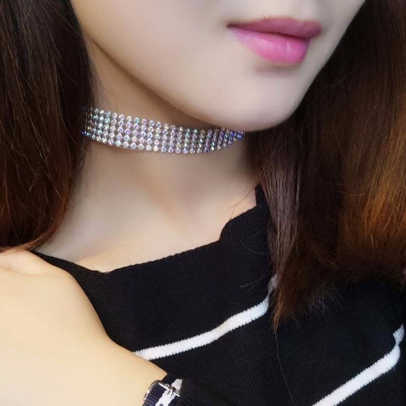 Close-up of a person wearing a sparkling choker necklace.