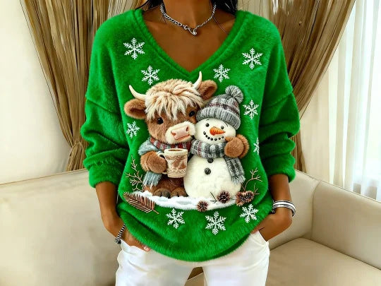 Green sweater with a cow and snowman design in a home setting