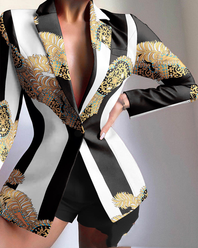 Black and white patterned outfit with gold accents on a plain background